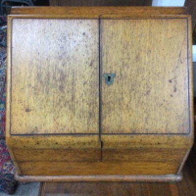 A stationary cabinet with glass ink wells.