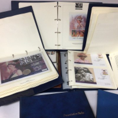 An album containing presentation packs and albums containing Royal commemorative coin covers and first day covers.