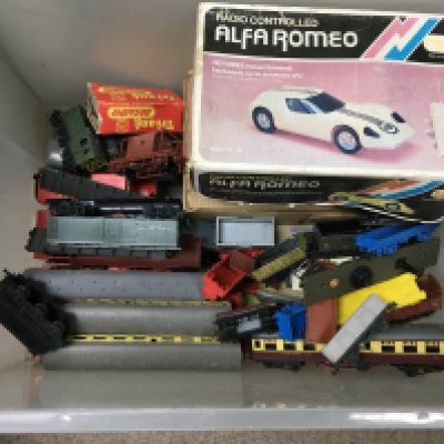 A box filled with a train set and other vintage toys.