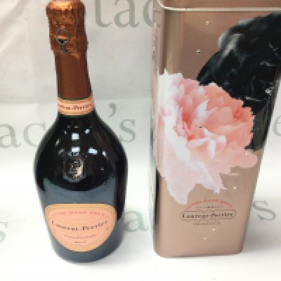 A bottle of Laurent Perrier rose champagne with tin.