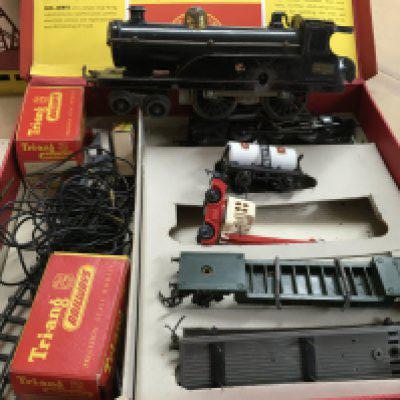 Two boxes containing toys including Scalextric Trix twin railway and tin plate solider on horse back .