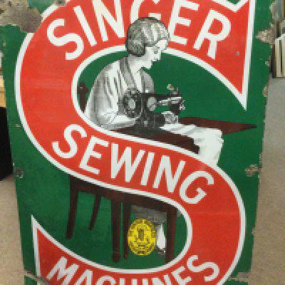 An enamel Singer sewing machine sign, approx 61cm x 91cm. Shipping category D.