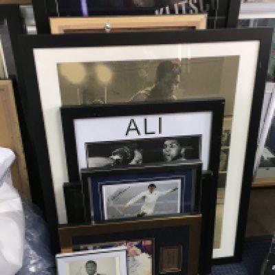 A collection of large framed sporting autographs including Forumla One, Boxing , tennis etc , framed and signed Spurs shirt, signed wrestling belts etc. Some autographs in this lot are printed. This lot cannot be posted