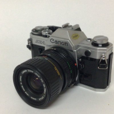 A Canon AE1 Camera with canon zoom lens.