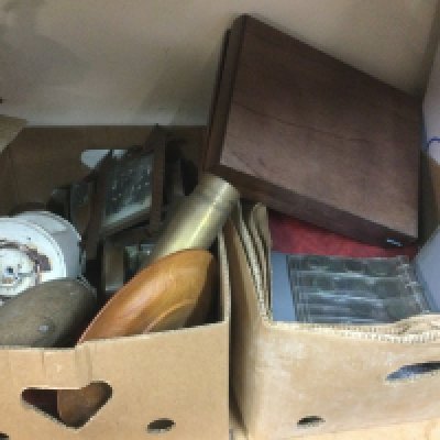 Three boxes of oddments comprising brass shell cases, decorative marine lamps, coins etc. Shipping category D.