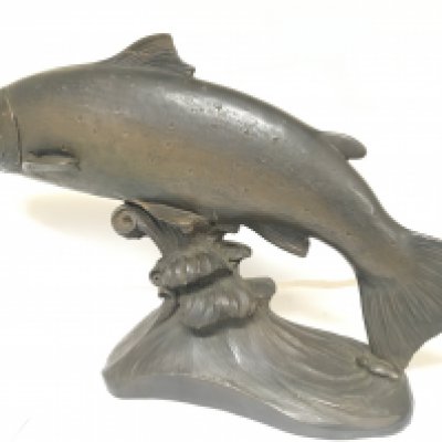 A large cold cast bronze of a leaping wild Salmon on a scrolling wave. Signed by B Elton length 64cm.