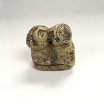 A hand carved stone amulet.