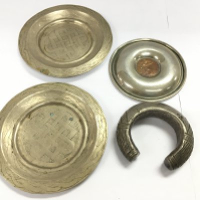 A Nigerian slave bangle and three silver plated dishes. Postage B