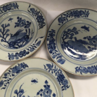 Three Early 19 th Chinese blue and white plates decorated with birds flowers and foliage.
