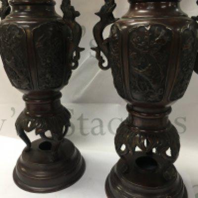 A pair of Japanese bronze vases with raised birds flowers and foliage . 40 cm .