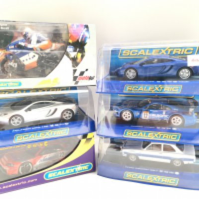 6 Boxed Scalextric Vehicles. Including 2 McLaren MP4-12c. A Dodge Viper. A Ford Escort MK 1. A Nissan Skyline And a Moto GP Neil Hodgson Bike.