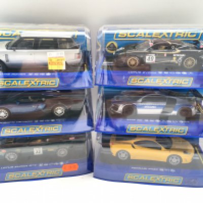 A Collection of 6 Boxed Scalextric Cars. A Range Rover. A Bugatti Veyron. A Audi R8. A Ferrari F430. And 2 Lotus Evoras.