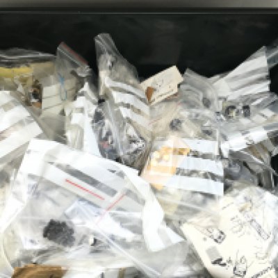 A Box Containing Many Scalextric Spate Parts.