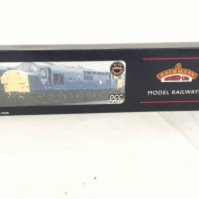 A boxed 00 gauge DCC ready locomotive by Bachmann featuring 32.776K. Class 37 diesel weathered. No reserve