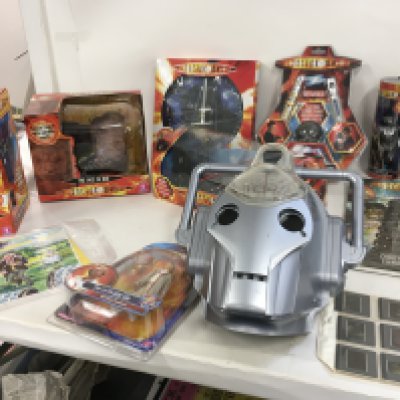 A collection of boxed Dr Who toys including Electronic Flight Control Tardis. The face of Boe with moveable mouth. Micro universe 3 spaceship set. The Firth Doctor. Dalek Wallclock. Sonic and Laser Screwdriver set. Cyber man with rotary toothbrush. Set of 12 viewing slides featuring first 8 doctors and others. Advent Calendar 2009. Waterbottle and a used cyberman electronic mask. Plus a limited print featuring the 1st Doctor and the Daleks signed by Walt Howarth with COA.