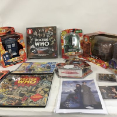 A collection of unopened boxed Dr Who Toys plus other items comprising Tardis Talking Moneybank. The Face of Boe with moveable mouth. Jadson Trooper. Davros. Sonic and Laser Screwdriver set..Dalek Medal..various Doctor stickers. Tardis Operators licence. Collectors edition 2015 calendar. First dat issue stamps The Poison Sky. Signed print featuring Dr who. Sarah Jane and K9. Art print featuring Doctor. Jane and Dalek in Tardis. Signed by Walt Howarth. COA