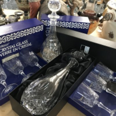 Crystal wine glasses in boxes and a boxed Royal Doulton decanter, together with another crystal decanter