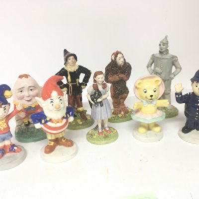 A collection of Royal Doulton Disney and other caricature figures Humpty Dumpty Yellow Brick Rd figures all in boxes. (9)