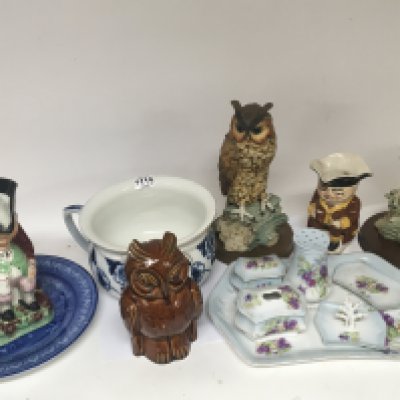 A collection of ceramics owls Toby jugs decorative plates.