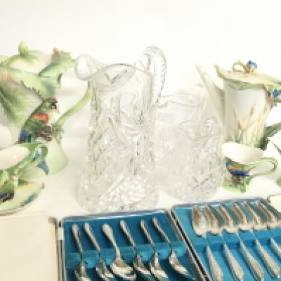 A collection of Franz porcelain jugs and cups, cut glass jugs, silver plated cutlery etc.