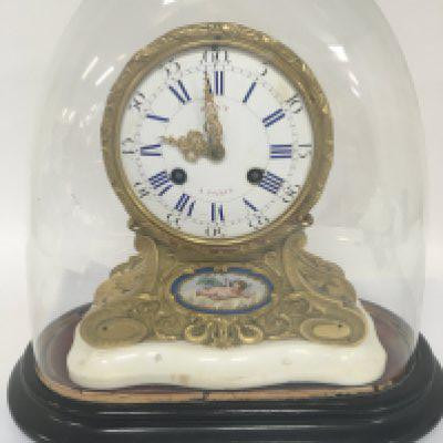 A French late 19th Century clock under a glass dome with an enamel dial with inscription Dent A Paris. With Sevres style hand painted plaque. With pendulum ans striking on a bell Height including dome 37cm.