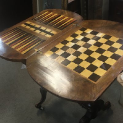 A Victorian inlaid walnut games workbox the hinged top with games board above a single drawer on turned legs.