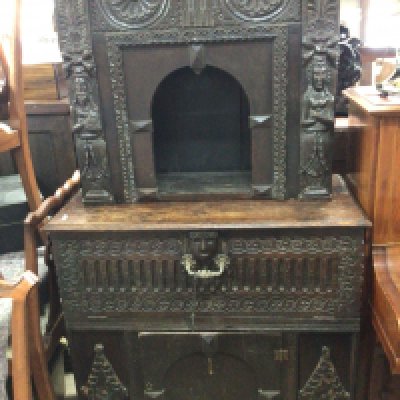 An 18th Century carved oak two section cabinet cupboard the top section with an open arch above a fall front above a cupboard. Hight 173cm x 94cm x 45cm