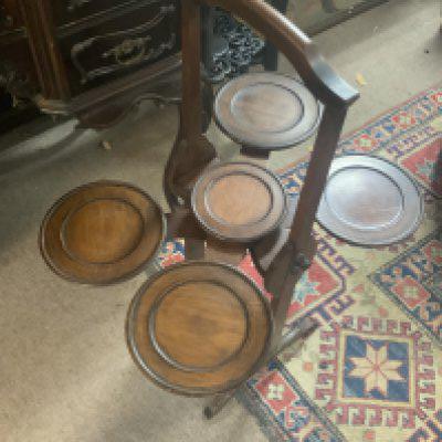 A 1920s Victorian mahogany folding plate stand.