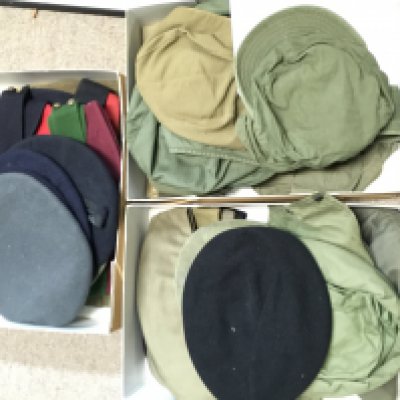 A collection of US military hats including Korean war, Vietnam war and other British examples
