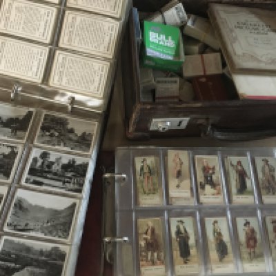 A suitcase containing cigarette cards together with two cigarette card albums