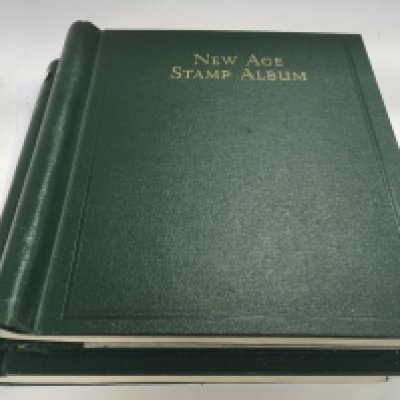 A large collection of mounted mint Queen Elizabeth commonwealth postage stamps from 1952-1962, housed in 2 new age albums.