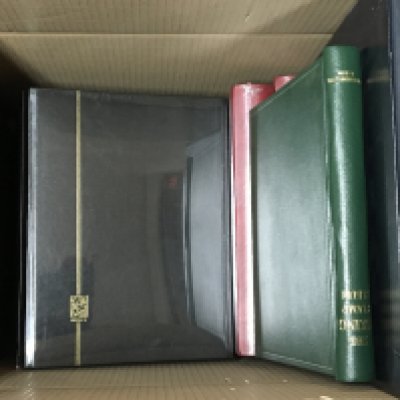 A box containing unused Stamp albums Stanley Gibbons Great Britain A Chanel Island album and many others some still in cellophane. (a lot)