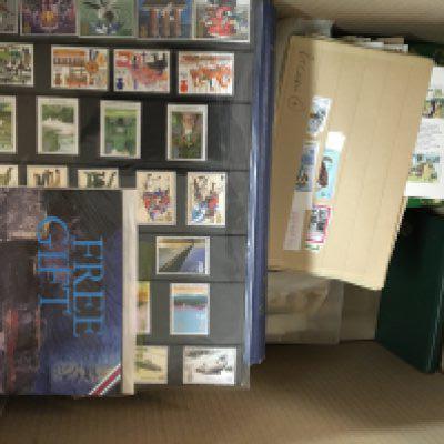 A box containing mixed stamps used and unused British and Commonwealth and an album of world stamps