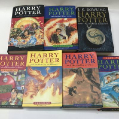 7 harry potter books including three 1st editions.
