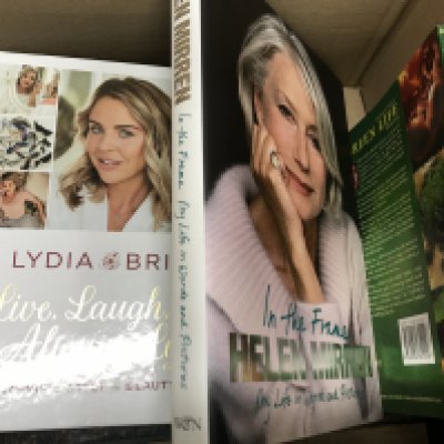 A box containing various books including Treasure Island according to Spike Milligan, The Cook Pack by Gary Rhodes, Des O'Connor autobiography, Barbara Windsor autobiography, Joan Collins and Helen Mirren etc
