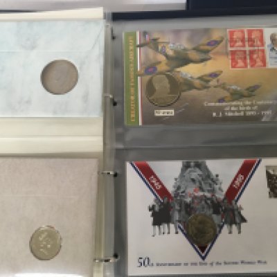 Three blue albums containing Royal Mail Philatelic Numismatic covers coin covers (3)