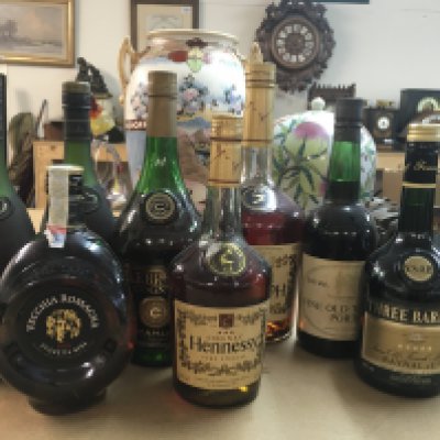 A bag containing various alcoholic drinks including large Hennessy Cognac, Three Barrels Brandy, RemybMartin champagne and port