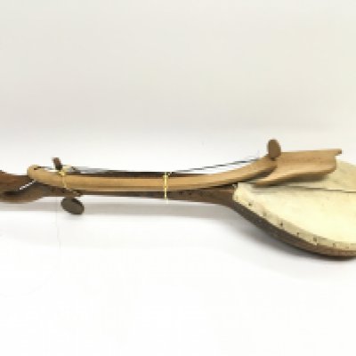 A wooden Gusle with a carved design body and skin drum cover ,approximately 60Cm long. postage category C