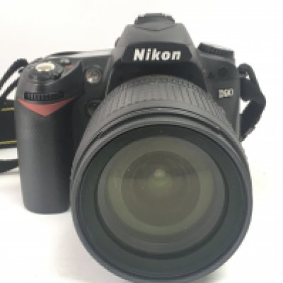 A Nikon D90 camera with a DX AF-S Nikkor 18-105mm 1:3.5-5.6G ED lens and accessories. Postage category C