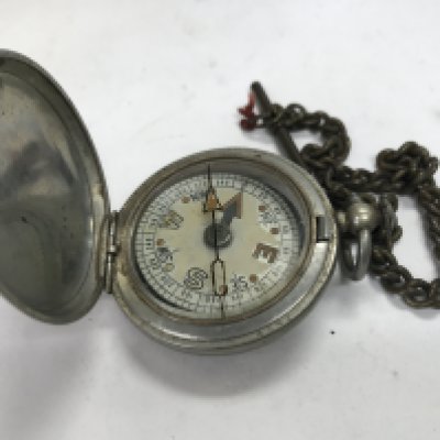 A military compass and a large plane compass.
