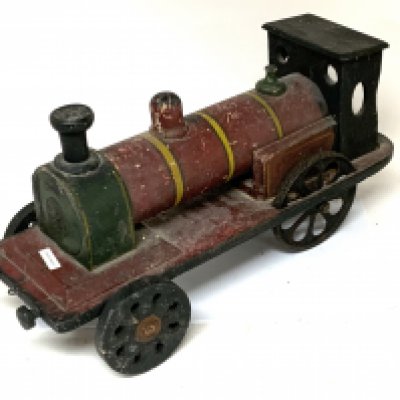 A Vintage Wooden model toy steam train. Pressed brass panel to front stamped JOYBOY, strength in the toy is Joy in the Toy. Overall length 53cm. Playworn condition. (C)