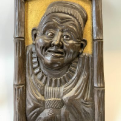 A 20thC Japanese Guardian carved wooden panel inset with moveable glass eyes. (C) 52cm x 30cm