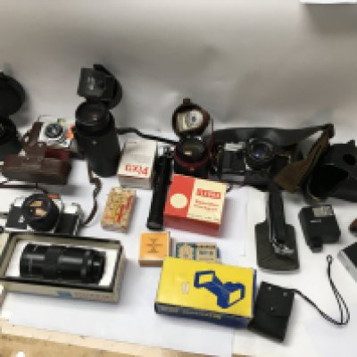 A collection of camera equipment including zoom lenses and other accessories.