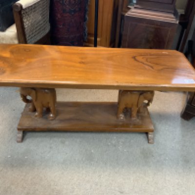 A carved hardwood table the pillars in the form of elephants. 96cm x 38cm x 34cm. NO RESERVE