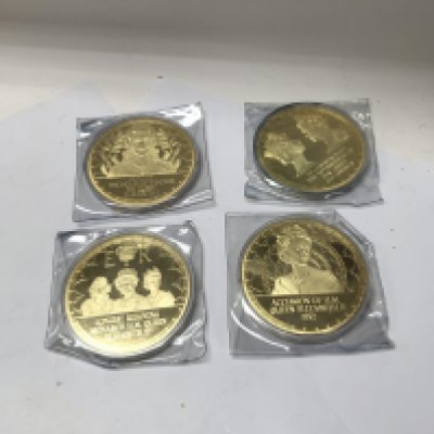 A collection of large gold plated commemorative medallions of Queen Elizabeth II and a cased set of god save the Queen coins. NO RESERVE