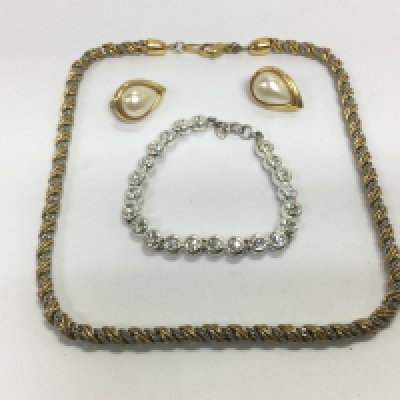 A collection of items including a titanium ring and bracelet (2) A Monet necklace, bracelet and earrings, not a matching set and A small collection of loose gemstones. Shipping category A- NO RESERVE