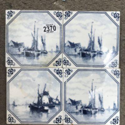 Four Delph tiles depicting sailing boats