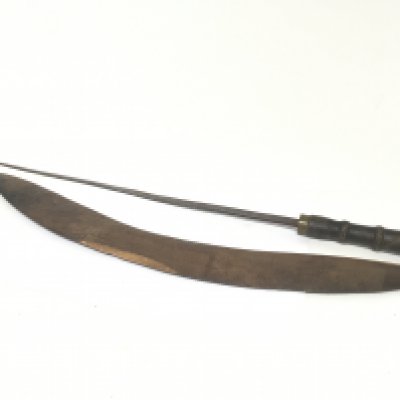 A carved hardwood Aboriginal boomerang and an African sword with leather grip and steel blade.