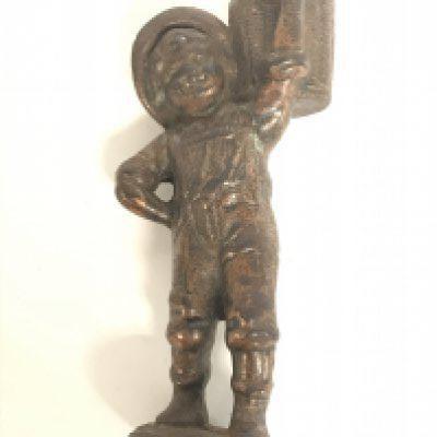 A vintage cast iron bar top cigar lighter of a boy with a basket. 14cm tall. Postage category B
