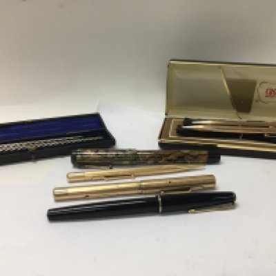 A collection of various pens including some silver and gold tipped examples.
